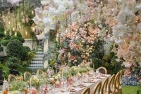 a gorgeous pastel garden wedding reception space with blooms all over, pastel blooms and greenery on the table