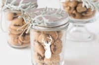 a jar with chocolate chip cookies, decorated with a deer silhouette and pale millet branches