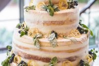 a large striped naked wedding cake with citrus, berries and mint plus white blooms and greenery is amazing