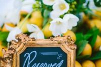a mini chalkboard sign is a refiend gilded frame is a lovely idea for a wedding, it will accent your reception tables a lot