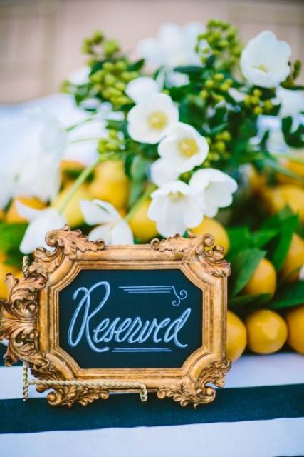 a mini chalkboard sign is a refiend gilded frame is a lovely idea for a wedding, it will accent your reception tables a lot