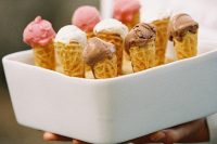 a porcelain stand with holes to hold ice cream cones is a stylish and elegant idea for a wedding