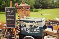 a pretty vintage trolley with an umbrella, a wooden stand with paper cups and cones, cotton decor and a chalkboard sign