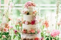 a romantic garden wedding cake – a naked one with bold blooms and colorful macarons plus pink ribbons is wow