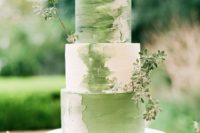 a romantic green and white brushstroke wedding cake with greenery for a bright spring wedding