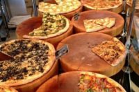a rustic pizza bar with wood slices for serving pizzas is a very creative and cool idea