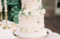 a sophisticated secret garden wedding cake in neutrals with sugar blooms and painted leaves, with fresh white flowers and ferns is amazing