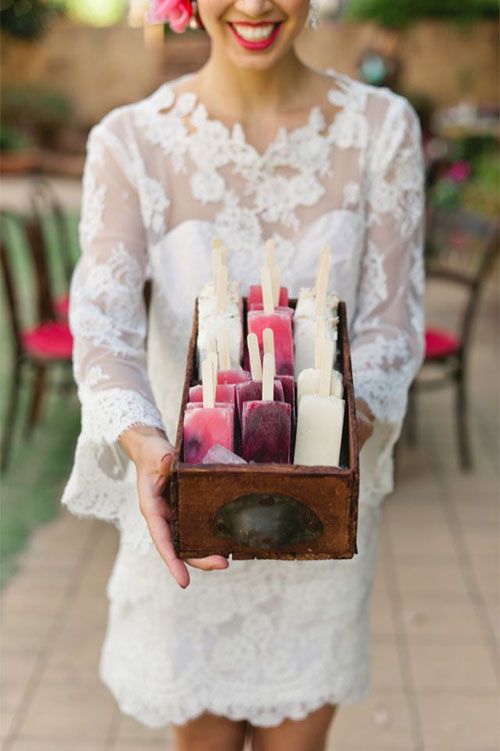 a stained box with popsicles is a lovely idea to serve ice cream at your wedding, great to add a vintage feel to it