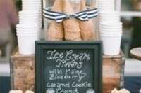 a stand with paper cups, waffle cones in a jar and some toppings and sticks for your ice cream is great for a vintage wedding