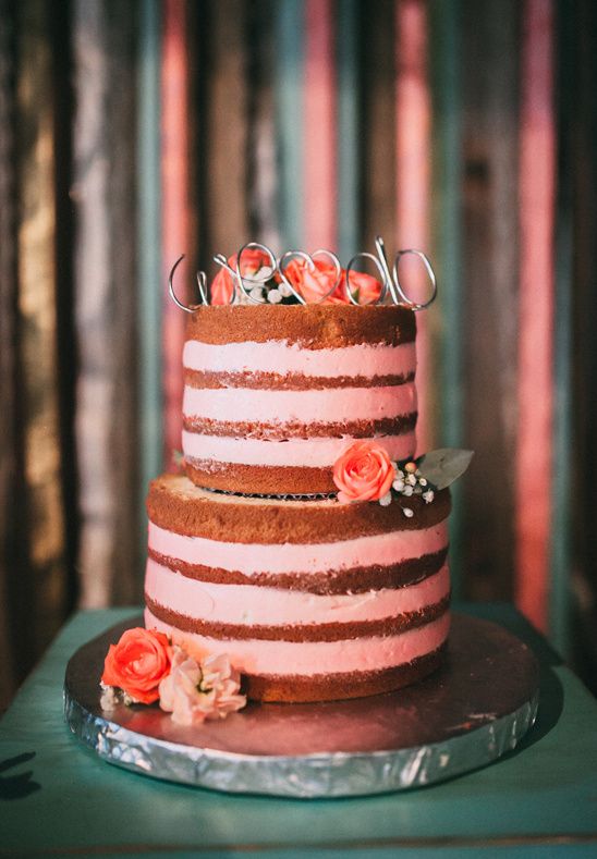 a striped naked wedding cake with bold blooms and a calligraphy topper is a lovely idea for a modern rustic wedding