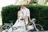 a white double bike with greenery and blooms and a chalkboard sign is a lovely idea for a wedding, if you love riding a bike