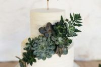 a white textural buttercream wedding cake with a topper and a fresh succulent decoration