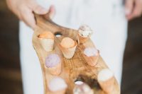 a wooden board with holes to insert ice cream cones is a lovely idea for a rustic or just relaxed and laid-back wedding