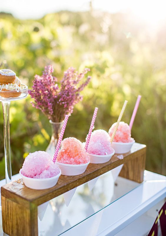 a wooden stand with paper cones filled with fruit ice is a great idea for a hot day wedding, they refresh a lot