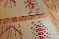 bold cardboard wedding invitations with red thread and names ebroidered are amazing for inviting your friends and family