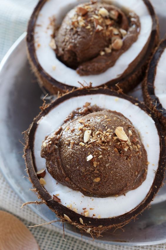 chocolate coconut avocado ice cream is served in coconut cups - a great idea for a tropical wedding and very creative serving