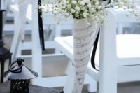 cones of note paper with baby’s breath are great to decorate the chairs of the aisle