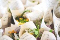flower petals in cones of note paper are a cool idea to serve petals for the wedding exit