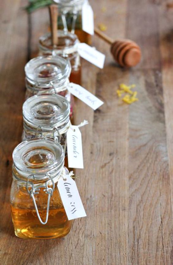 honey in small jars with tags is a cool idea for a rustic or summer wedding or rehearsal dinner