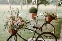 lovely bikes with baskets with neutral and pink blooms and greenery are great to decorate your wedding venue