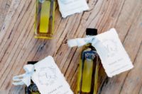 olive oil mini bottles with personalized cards and ribbon bows make a cool favor for a Mediterranean wedding