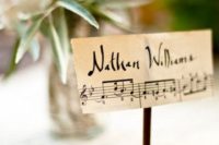 place cards made on note paper and placed on wooden stands are amazing to decorate the tables