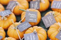 pumpkins with tags can be a nice idea for a fall wedding rehearsal dinner