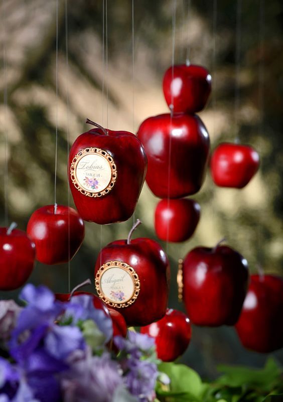red apples suspended with cards can be wedding favors or just creative wedding decor for a fairytale wedding or a fall one