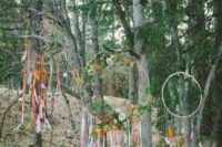 super colorful boho dream catchers decorated with greenery and bright flowers, with long colorful ribbons and feathers