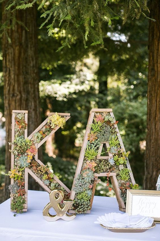 wooden monograms decorated with foliage and succulents are perfect for a modern rustic or woodland wedding
