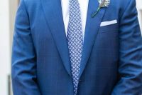 a bold blue printed suit and a printed blue tie – prints make the look more eye-catchy
