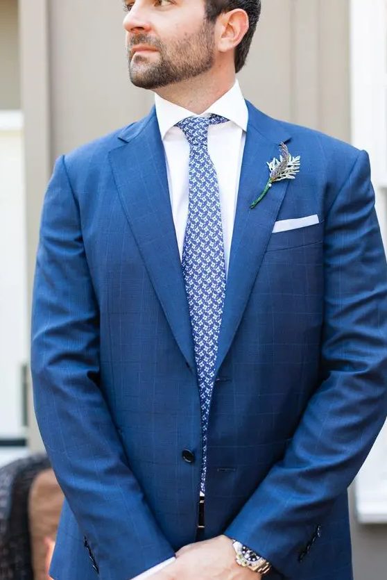 a bold blue printed suit and a printed blue tie - prints make the look more eye-catchy