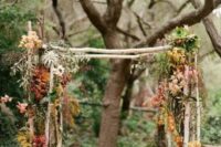 a simple yet stylish branch wedding arch
