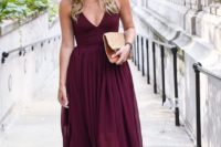 a burgundy strap midi dress with a deep V-neckline, a lace trim, nude heels and an embellished clutch