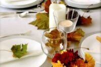 a casual wedding table setting with fall leaf runners, place markers and fall bloom centerpieces