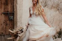 a chic bridal look with a beautiful A-line wedding dress with a lace bodice, a tulle skirt, white patterned cowboy boots and tassel earrings