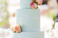 a chic mint green wedding cake with shiny ribbon, fresh pink and neutral blooms looks very bold