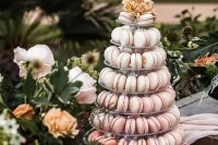 a chic ombre pink macaron tower with some blooms on top is a gorgeous idea for a spring or summer wedding, and will do for a torpical one