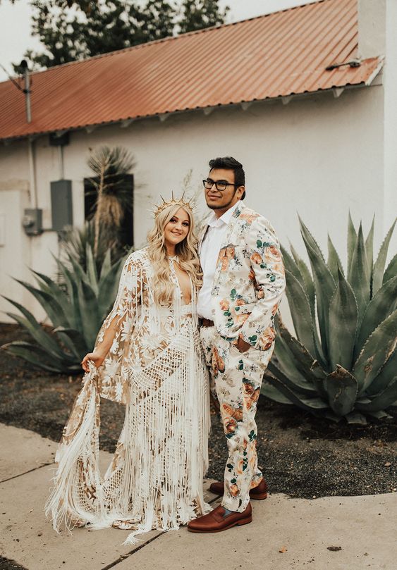 a colorful printed groom's suit with a white shirt and brown loafers are a cool and catchy combo for a boho groom