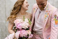 a crazy pink groom’s suit with pearls and embroidery plus some prints and a bolo tie is an amazing solution