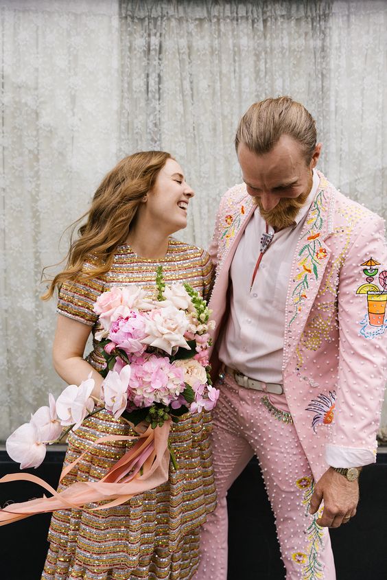 a crazy pink groom's suit with pearls and embroidery plus some prints and a bolo tie is an amazing solution