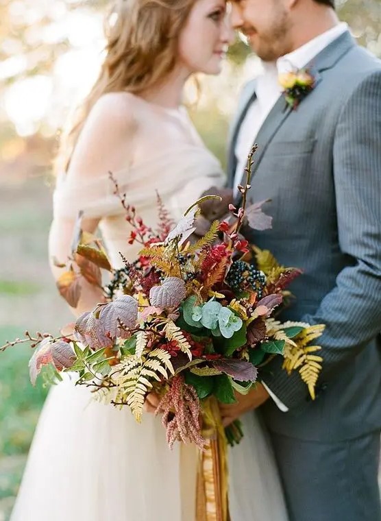 a fall boho romantic wedding bouquet with no blooms, berries and foliage of all colors possible