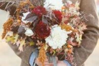 a fall-inspired dark wedding bouquet with leaves, herbs and white and burgundy blooms