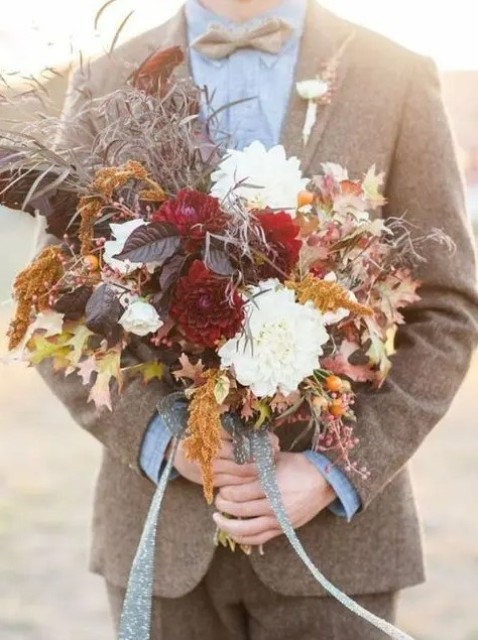 a fall-inspired dark wedding bouquet with leaves, herbs and white and burgundy blooms