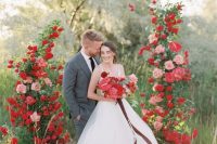 a fantastic red and pink wedding altar with lots of greenery will be a gorgeous idea for a wedding with such a color scheme