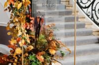 a gorgeous fall wedding program with greenery, bold leaves and bright blooms is an adorable idea for a fall wedding