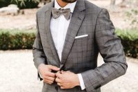 a grey plaid pantsuit, a white shirt, a grey bow tie are a stylish combo for a groom, in any season