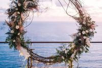 a large fall wedding wreath covered with white blooms, leaves, pampas grass and twigs plus LED lights is a very cool idea