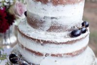 a naked wedding cake decorated with grapes and topped with a pear is a lovely idea for a fall boho wedding