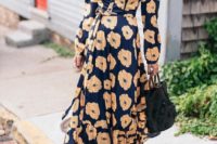 a navy floral maxi wrap dress with long sleeves, white shoes – just add a statement clutch and go